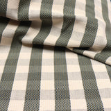 Detail of a draped hand-woven cotton fabric in soft cream in a plaid windowpane patter in cream, brown, teal and taupe.