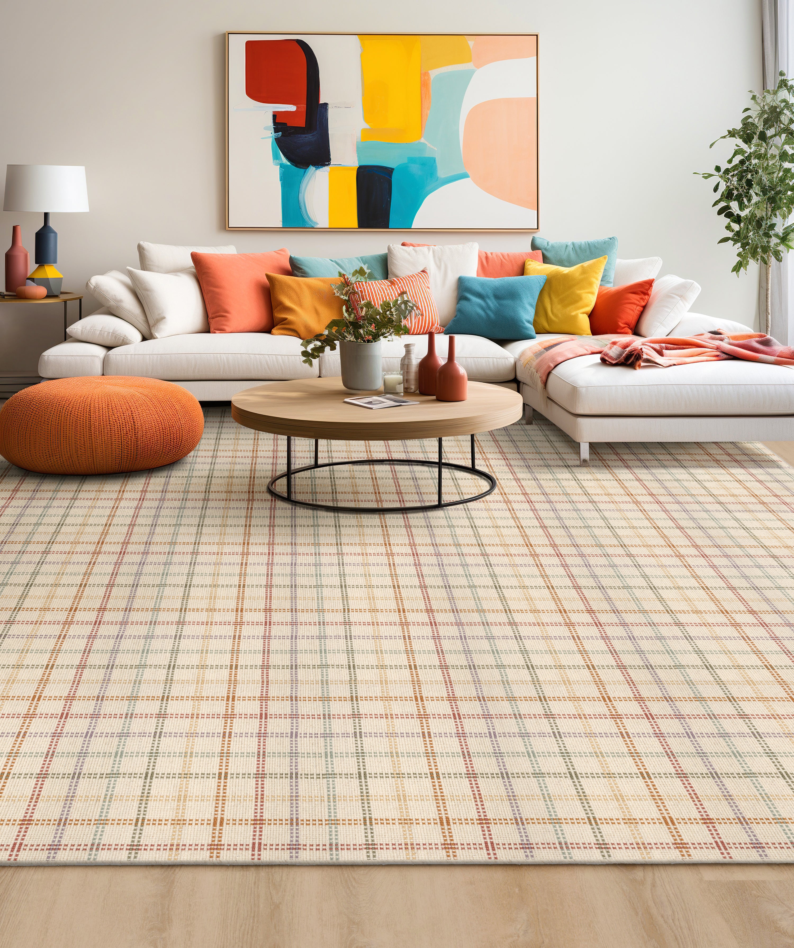 Living room interior with a white couch with brightly colored throw pillows atop a plaid area rug.