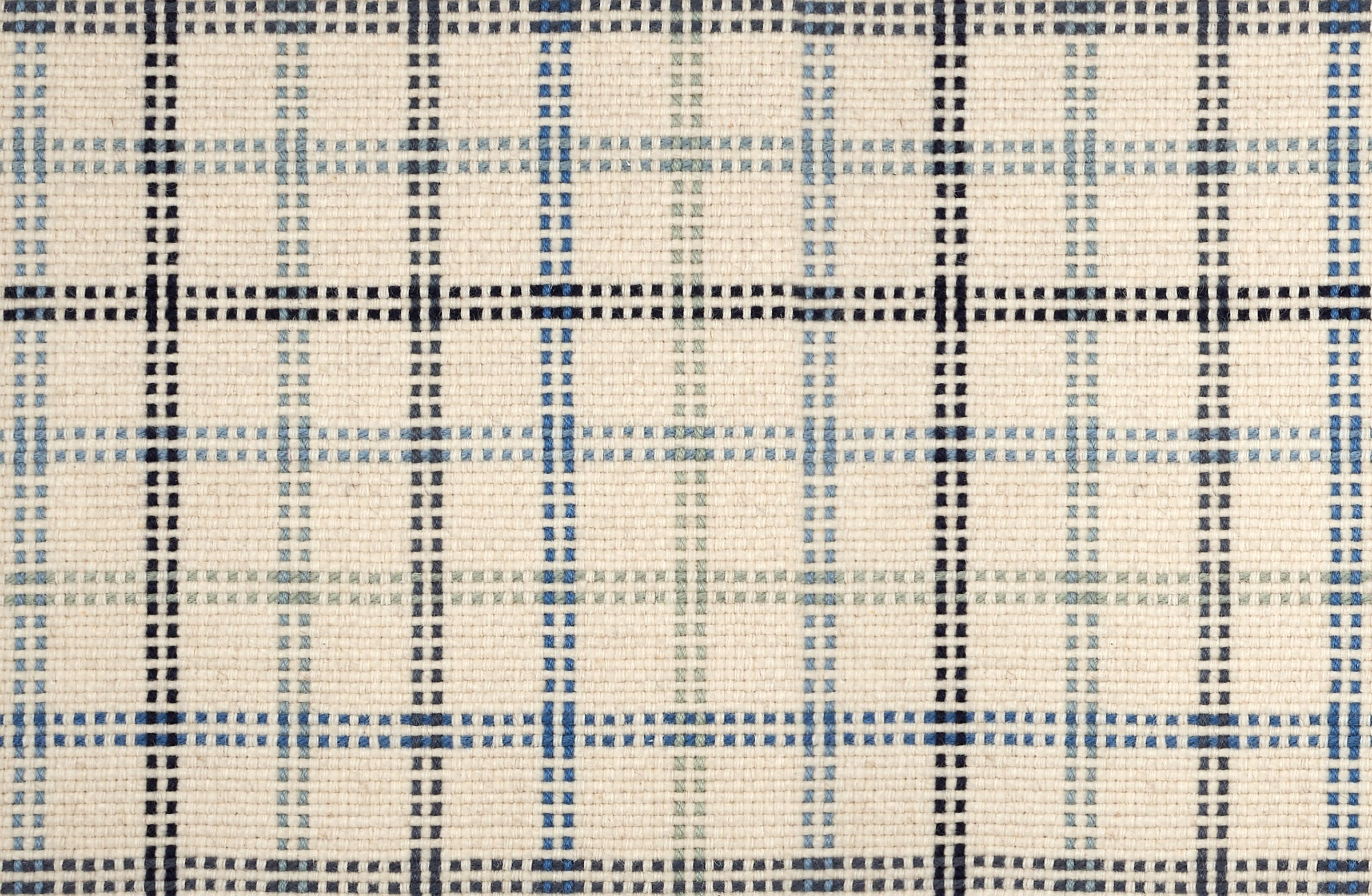 Broadloom carpet in a dashed window pane plaid in shades of blue on a cream field.
