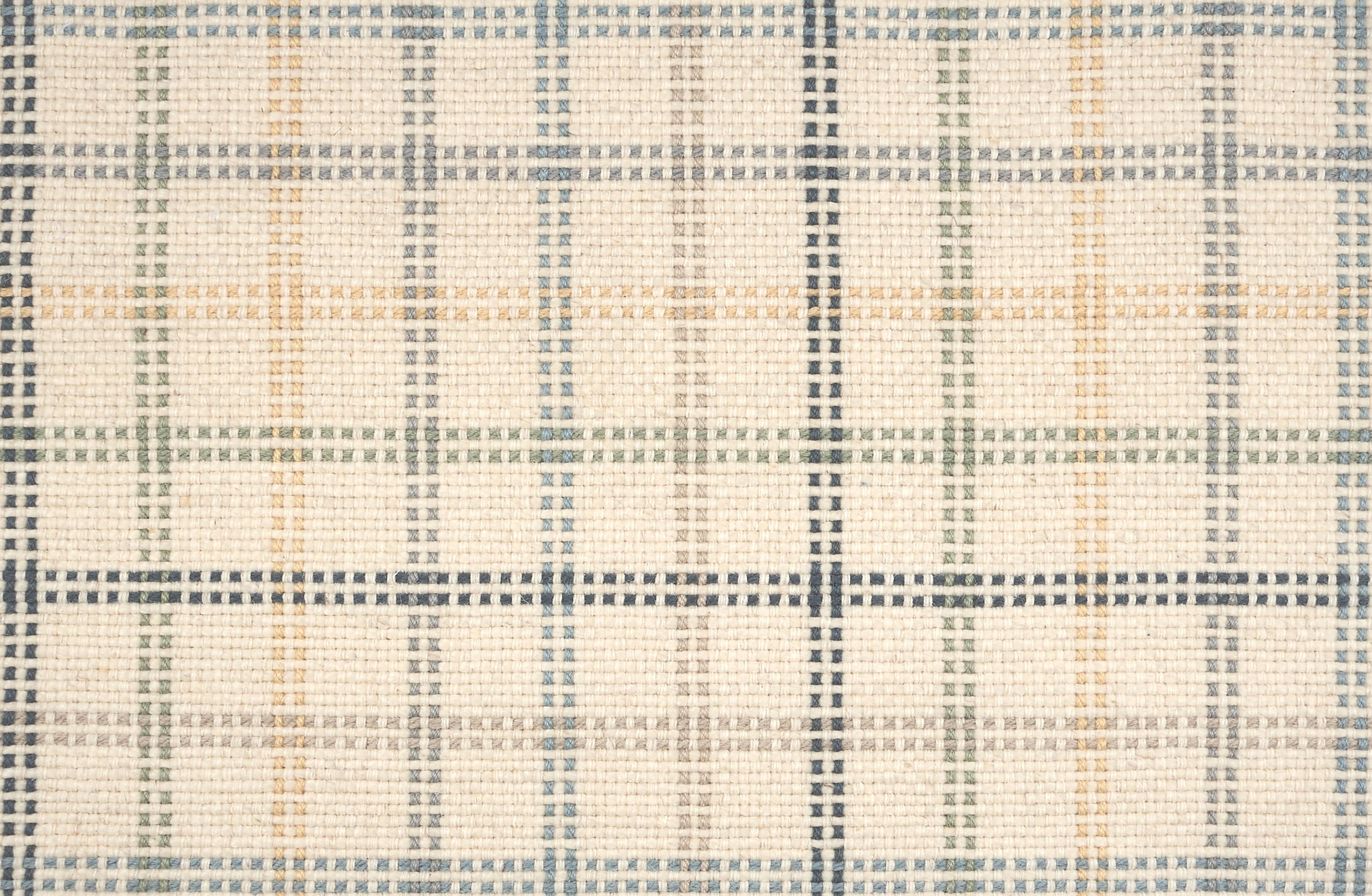 Broadloom carpet in a dashed window pane plaid in shades of blue, green and yellow on a cream field.