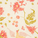 Detail of fabric in a bird and botanical print in shades of red and yellow on a cream field.