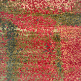 Handknotted rug sample in a pointillist textural design in shades of green, teal and tan on a red field. 