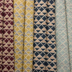 Collection of fabric swatches with geometric triangle patterns in various colors.