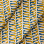 Draped close-up of fabric with a geometric leaf pattern in blue and ochre.