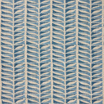 Close-up of fabric with a geometric leaf pattern in blue.