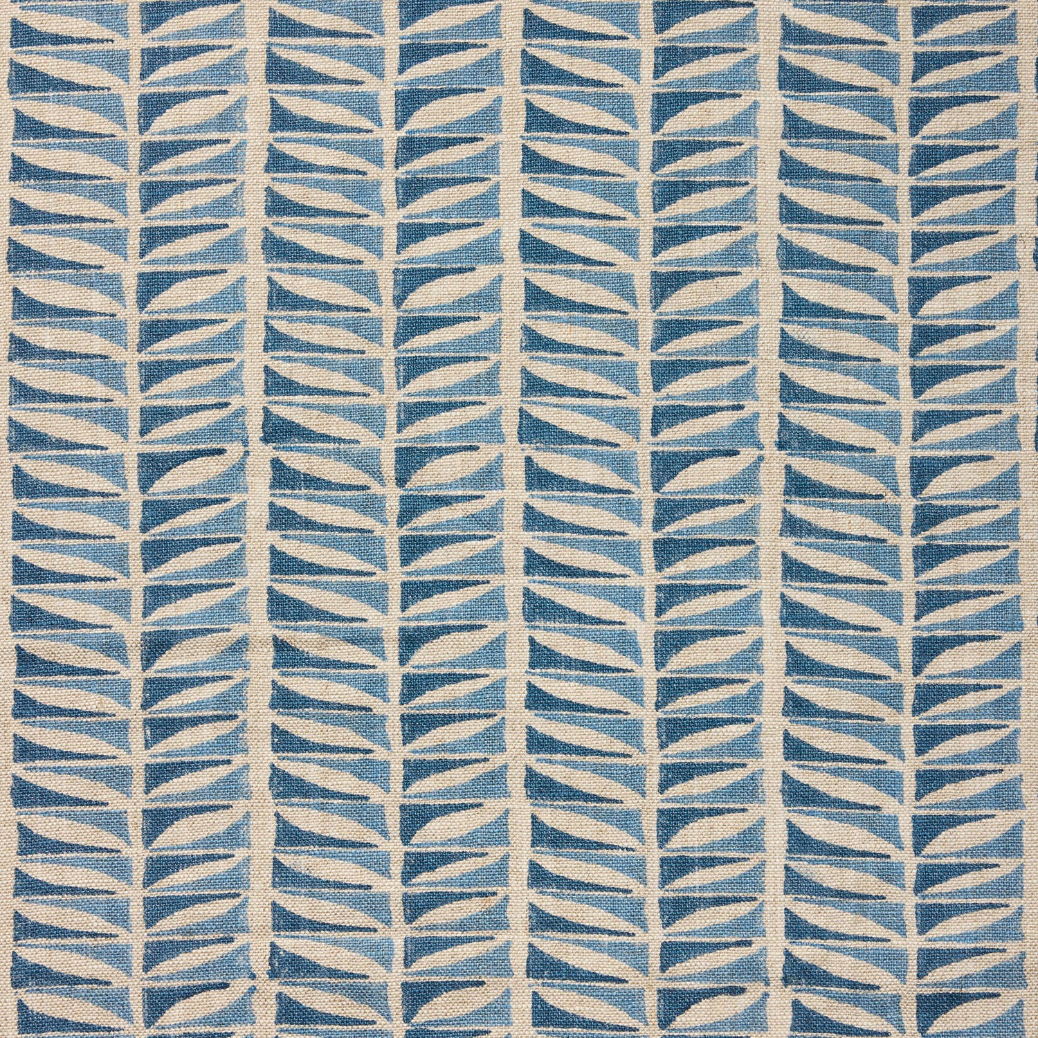 Close-up of fabric with a geometric leaf pattern in blue.