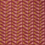 Close-up of fabric with geometric pattern in pink and ochre on a crimson field. 