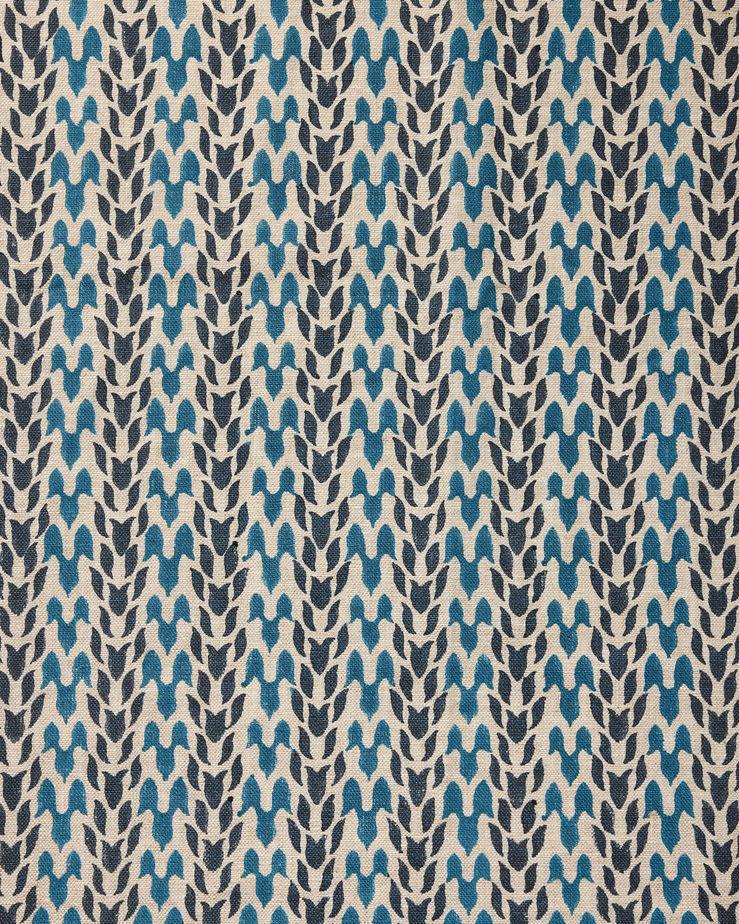Close up of fabric with abstract leaf pattern in shades of blue. 