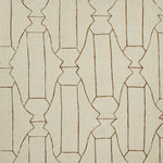 Woven fabric swatch in a repeating curvolinear print in rust on a tan field.