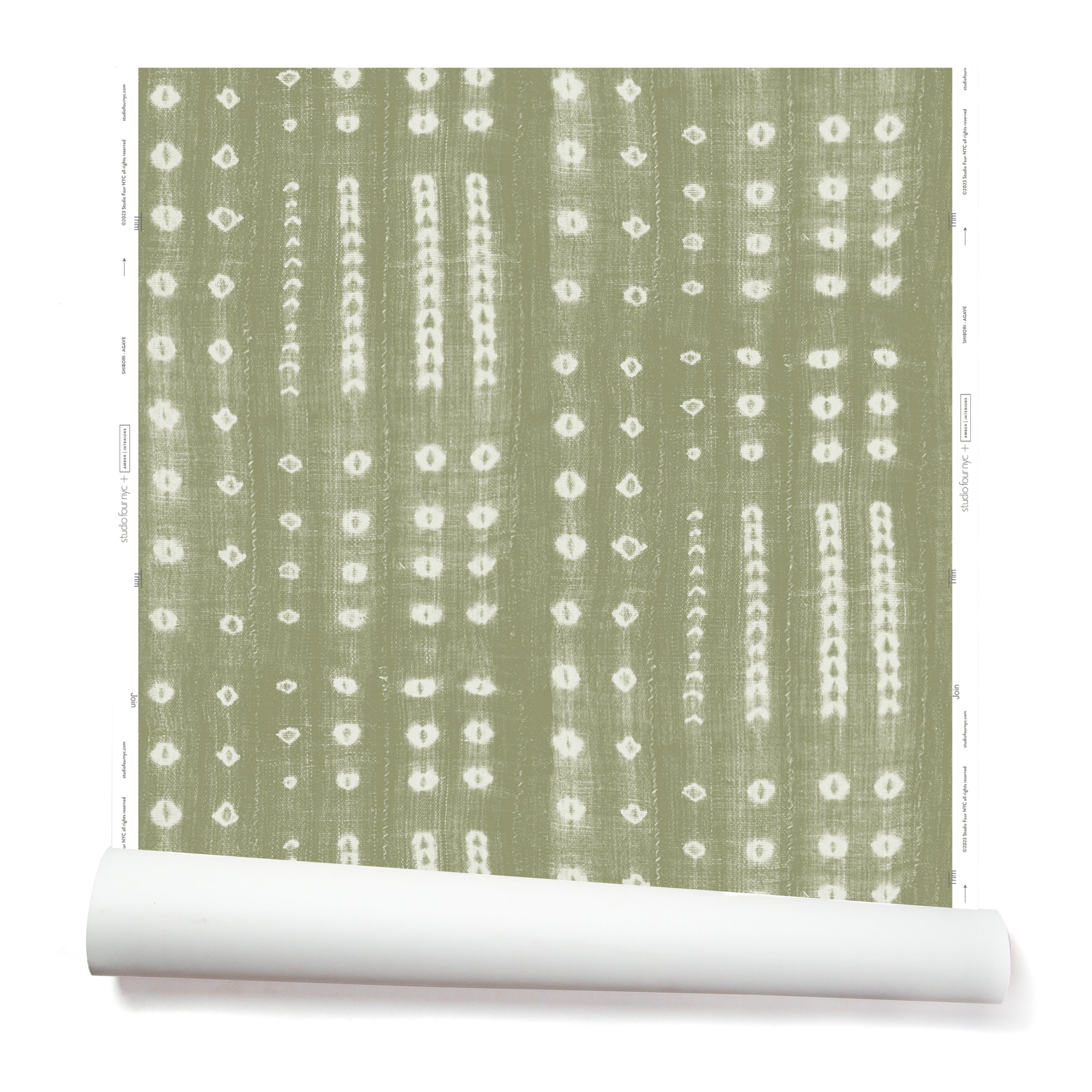 A partially unrolled roll of wallpaper in a striped print inspired by Japanese shibori on a sage green background.
