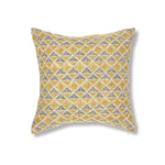 Block printed pillow with tan diamonds and navy cross hatched lines.