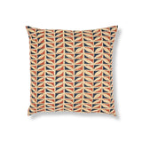 Block printed throw pillow with geometric leaf pattern in terracotta orange, beige, and dark navy blue on a white background.