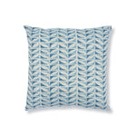 Block printed throw pillow with geometric leaf pattern in shades of light blue on a white background.