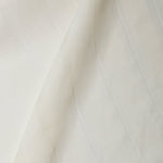 A draped swatch of sheer linen fabric in a cream color with a subtle striped pattern.