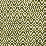 Detail of a handowven rug in an diamond like pattern in white and shades of green.
