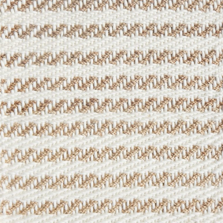 Detail of a textural rug in natural fiber and white yarn.