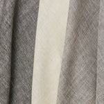 A row of three draped sheer interior fabric swatches in mottled gray and cream.