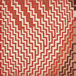 Detail of a flatwoven rug in a graphic diamond pattern in shades of orange, rust and brown