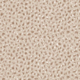 Detail of fabric in a painterly animal print in cream and brown on a tan field.