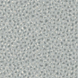 Detail of fabric in a painterly animal print in cream and blue on a light blue field.
