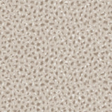 Detail of wallpaper in a painterly animal print in white and brown on a sable field.