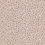 Detail of wallpaper in a painterly animal print in cream and brown on a dusty pink field.