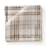 Fabric swatch with watercolor plaid pattern in shades of dark brown.