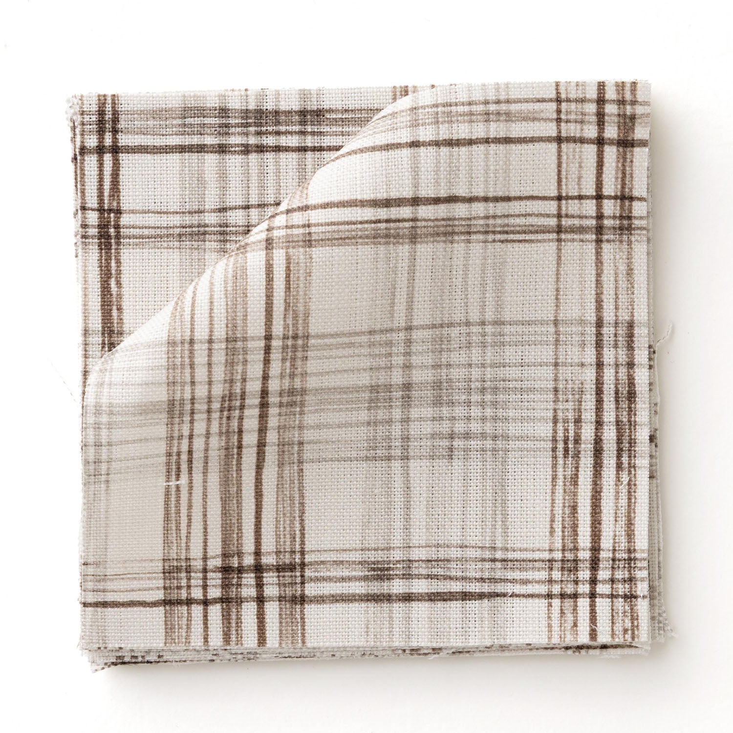 Fabric swatch with watercolor plaid pattern in shades of dark brown.