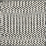 Textured rug with a herringbone pattern in white and slate blue. 