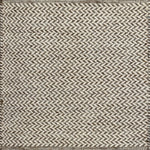 Textured rug with a herringbone pattern in white and brown.
