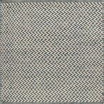 Textured rug with a herringbone pattern in white and teal.