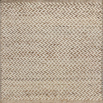 Textured rug with a herringbone pattern in white and tan.