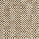 Detail of handwoven rug with diamond pattern in cream and shades of brown. 