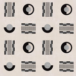 Graphic geometric pattern of circles, and stripes in black and grey on a cream field.