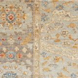 Detail of a Handknotted rug with an ornate Damascus design in blue, grey, and tan. 