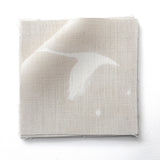 Stack of fabric swatches in a flying geese and star pattern in white on a pale ecru watercolor field.