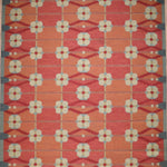 Decorative rug with geometric pattern on a red background