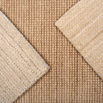 Close up of broadloom carpet samples in neutral colors. 