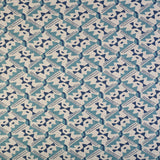 Detail of fabric in painterly diamond print in blue and navy on a white field.
