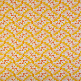 Detail of fabric in painterly diamond print in yellow and orange on a white field.