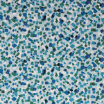 Detail of fabric in a playful polka dot print in shades of white, blue and green on a light blue field.