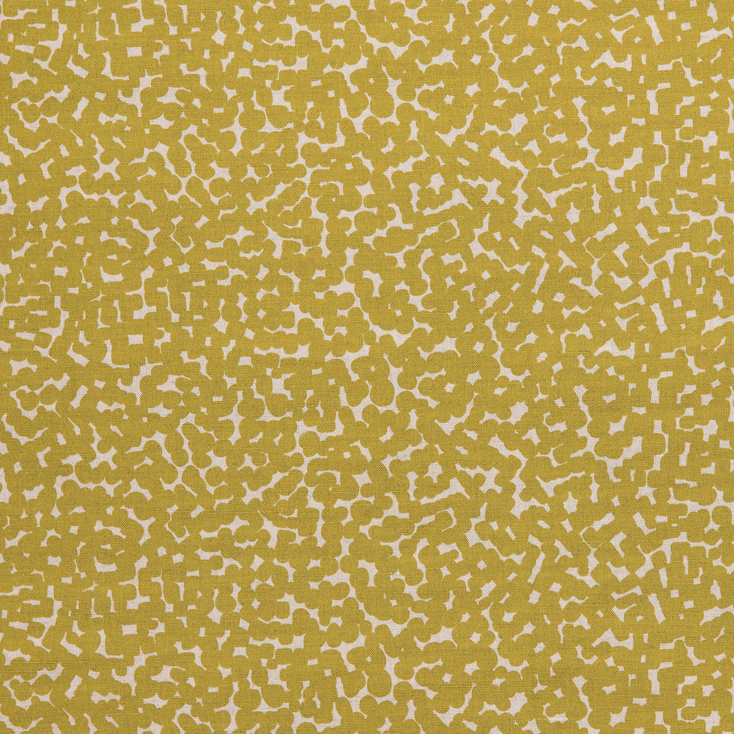 Detail of fabric in a playful polka dot print in mustard on a cream field.