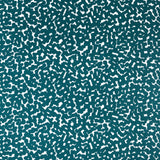 Detail of fabric in a playful polka dot print in turquoise on a white field.