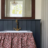 A chabby-chic sink with a ruffled fabric skirt in a playful polka dot print.