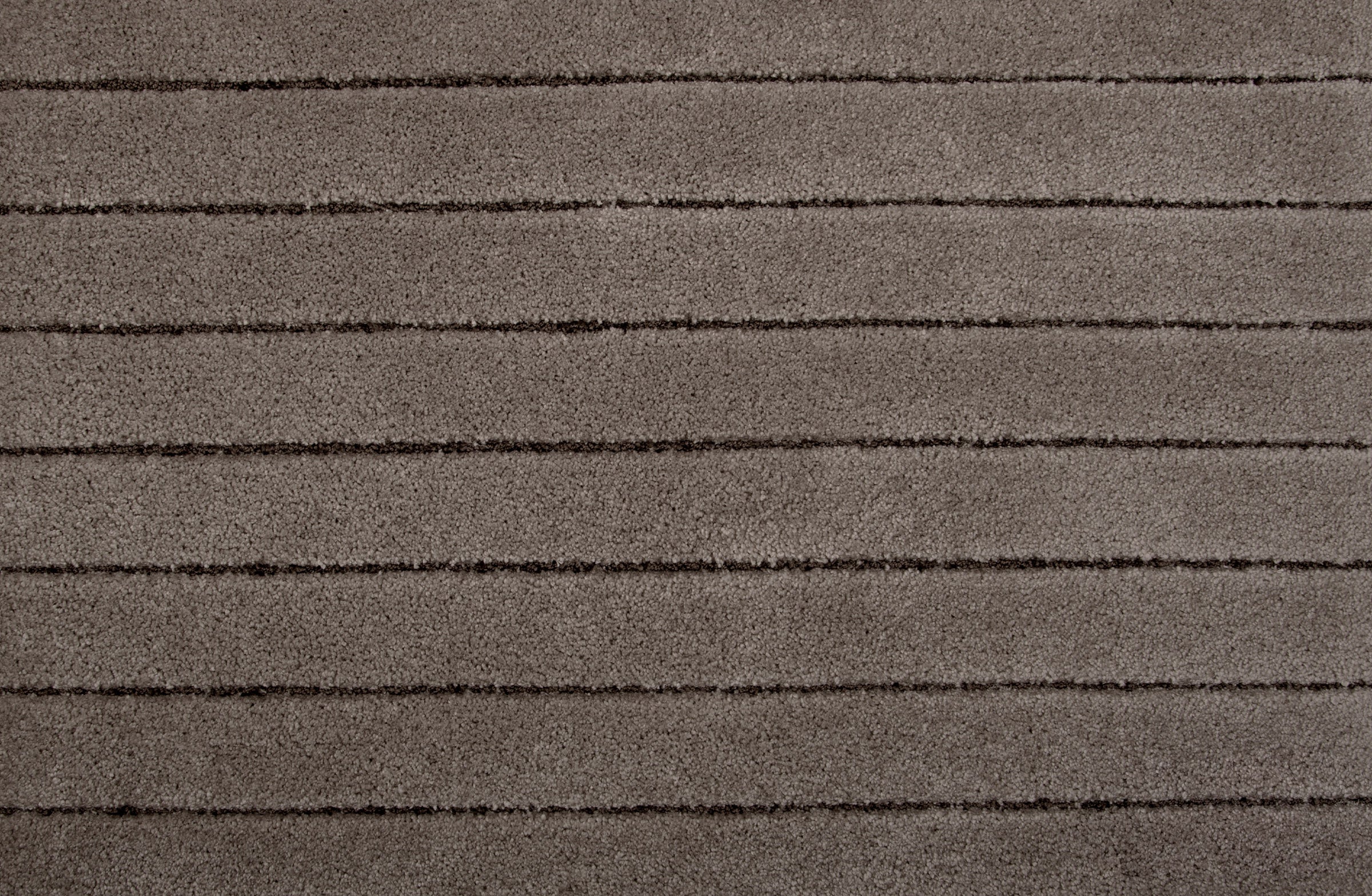 Broadloom carpet in a wide stripe pattern in tonal taupe.