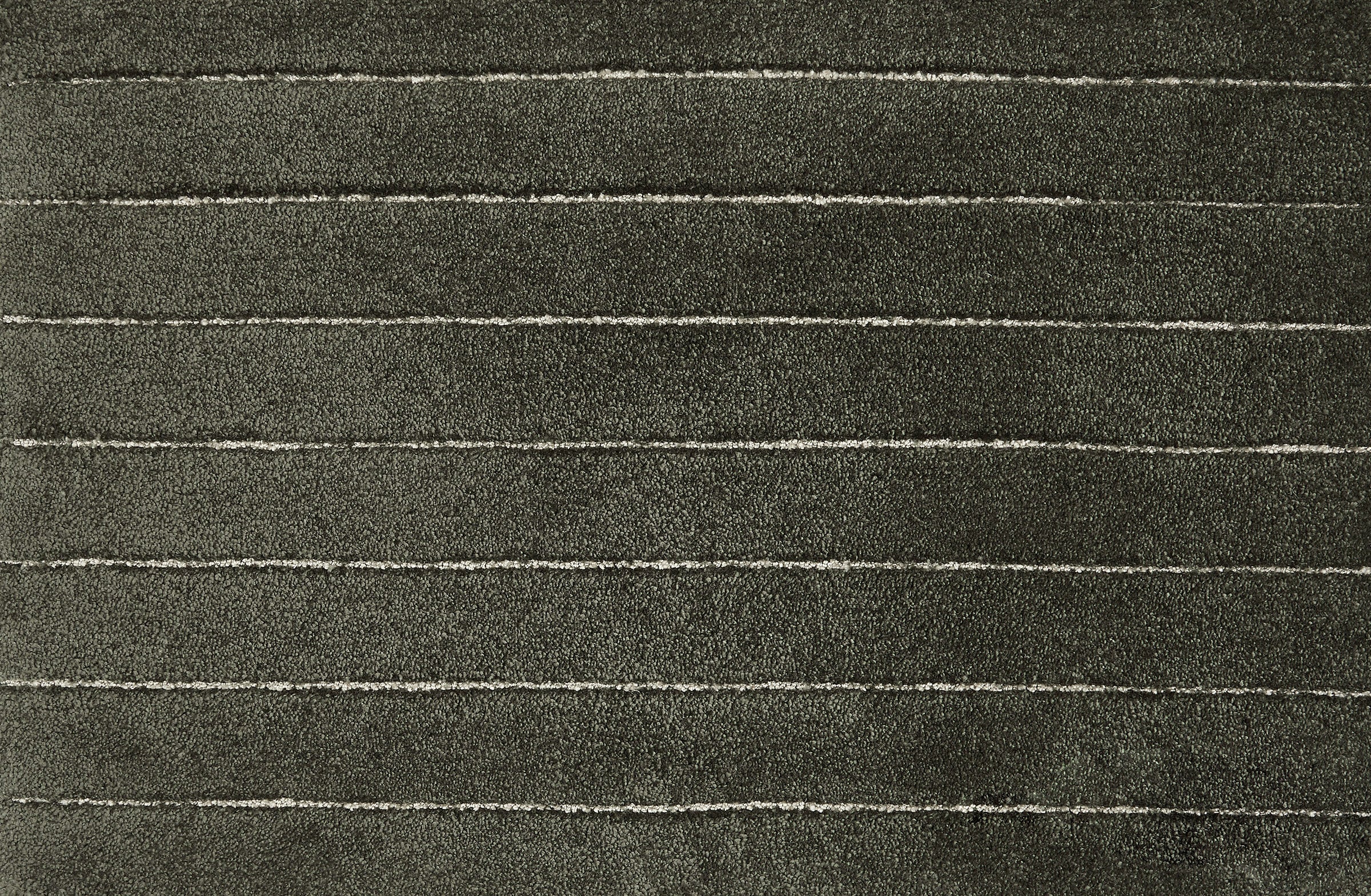 Broadloom carpet in a wide stripe pattern in deep dark green.