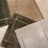 Pile of broadloom carpet samples in rich neutrals 