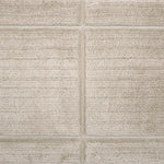 Textural performance broadloom carpet in grid design in beige.
