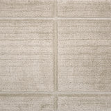 Textural performance broadloom carpet in grid design in beige.