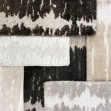 Stacked broadloom carpet samples in a contemporary abstract design in neutral colors. 